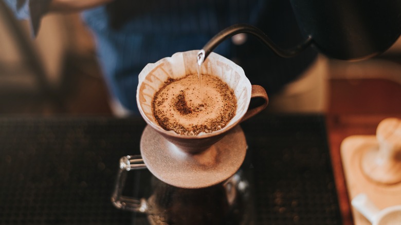 barista making pour over coffee