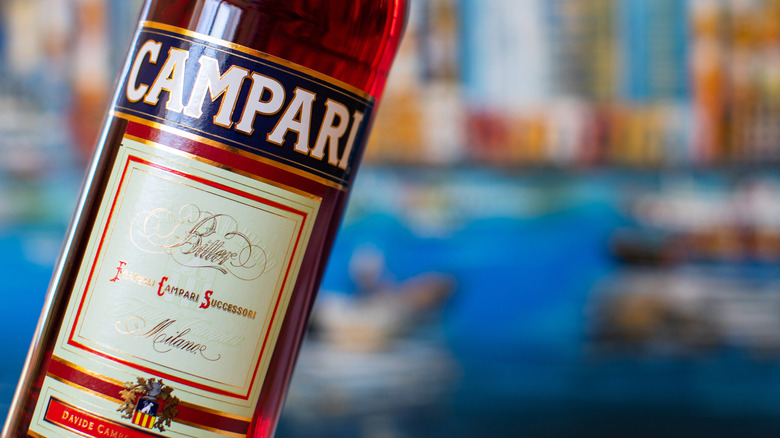 Campari bottle in front of water