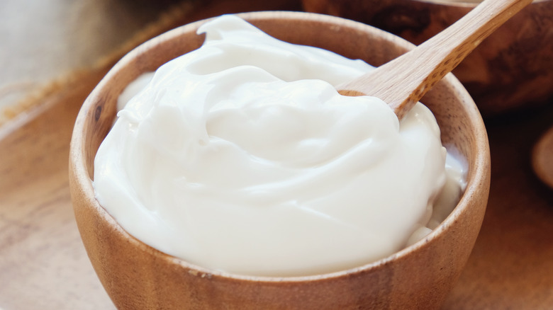 Non-dairy whipped cream in a wooden bowl with spoon