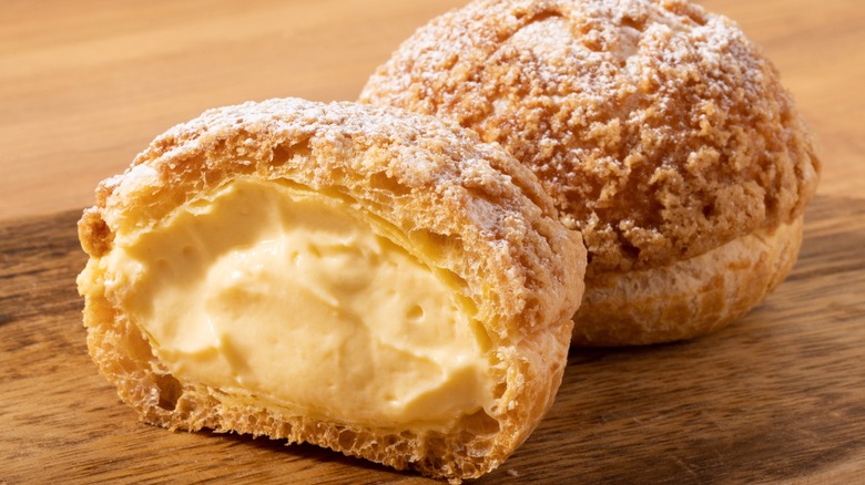 two cream puffs cut open