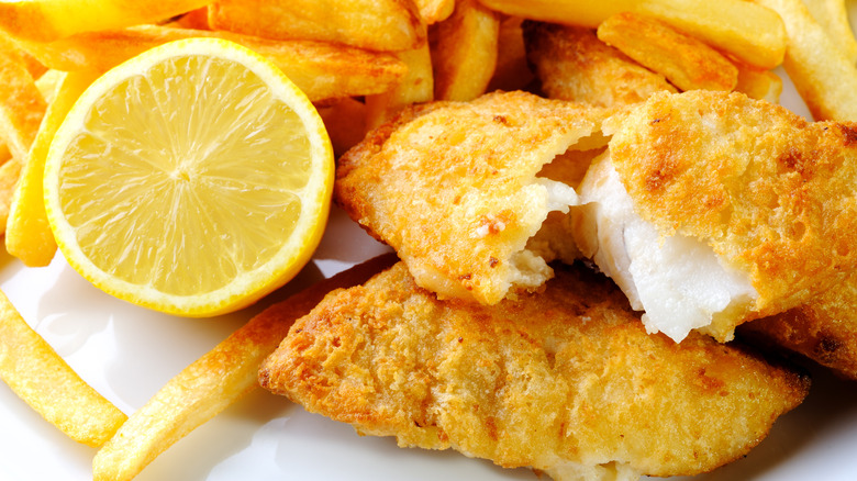 Breaded fried fish with fries and lemon