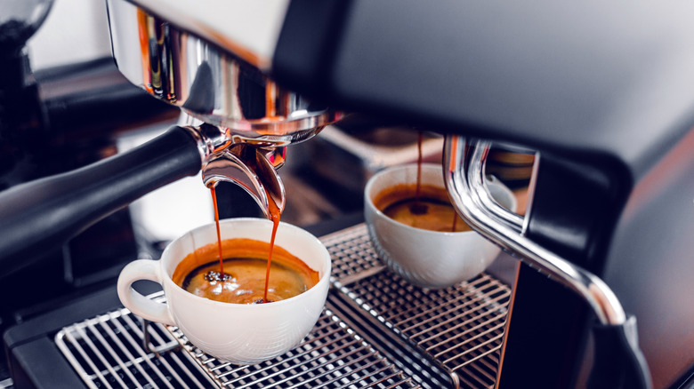 espresso pouring coffee into cup