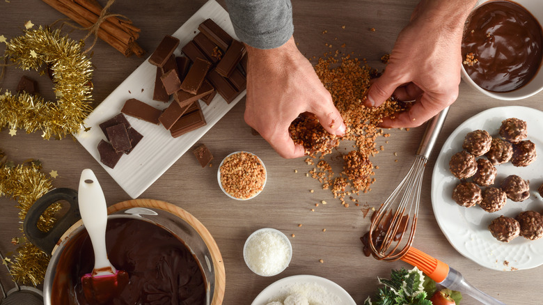 person making chocolate balls