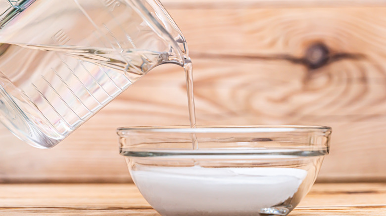 Pouring water into sugar