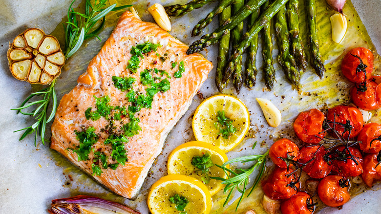 cooked salmon with vegetables on sheet pan