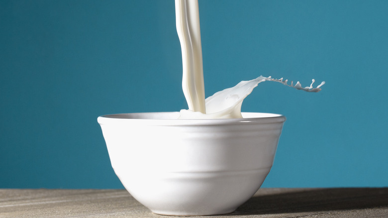 Milk being poured into bowl