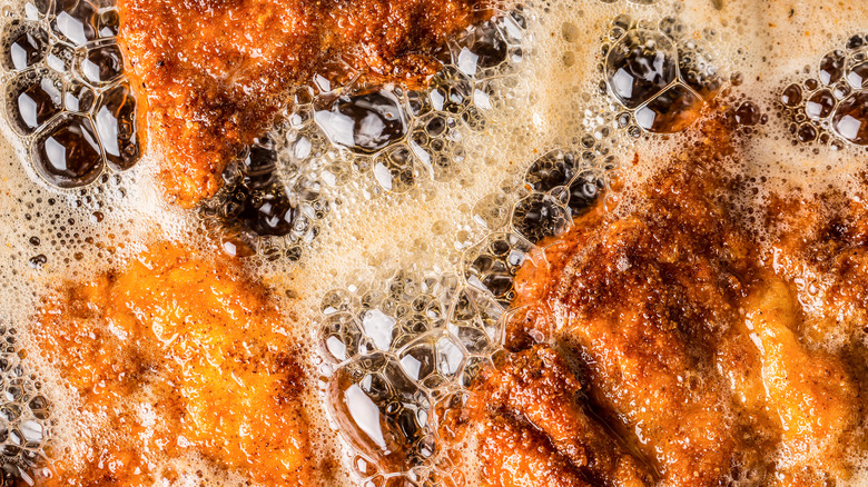 wiener schnitzel frying in oil