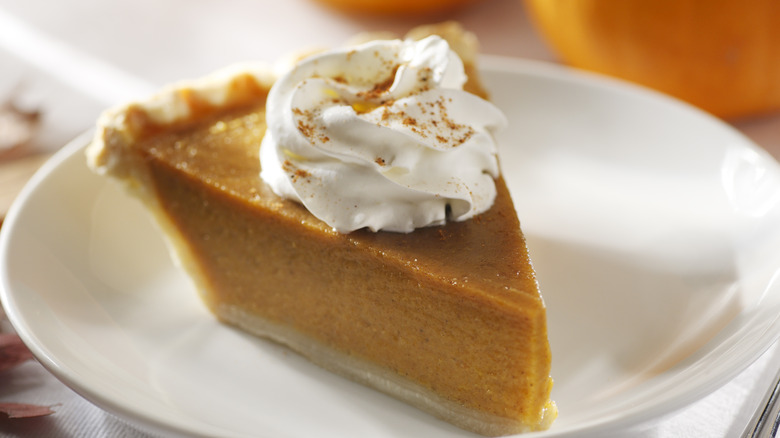 pumpkin pie slice with whipped cream