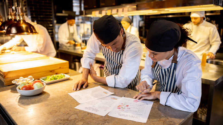 Chefs looking at menu