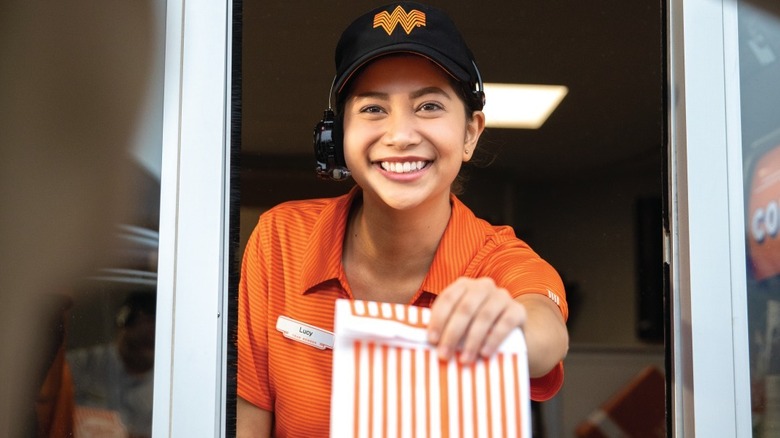 A Whataburger employee smiling 