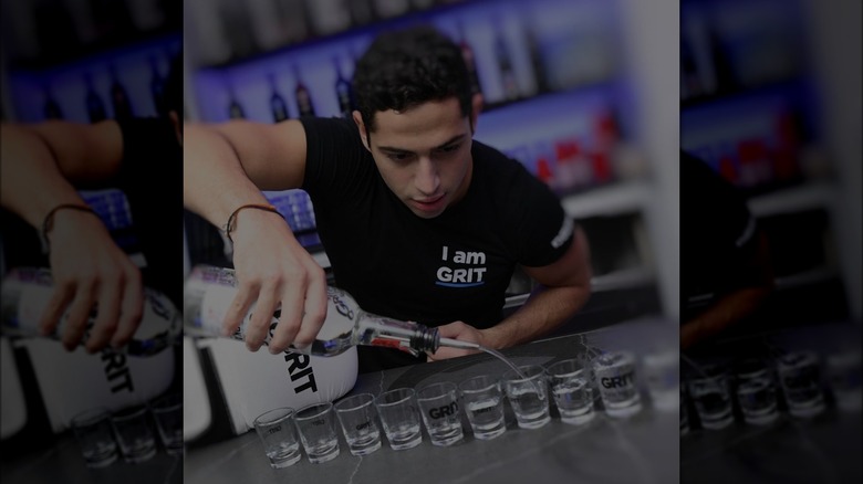 Grit boxing bartender pouring shots