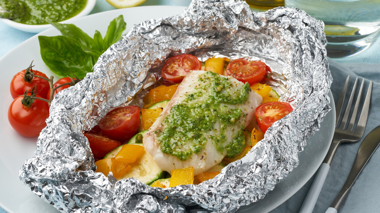 Fish and tomatoes in foil a packet