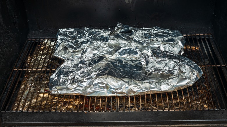 Food wrapped in foil on a grill