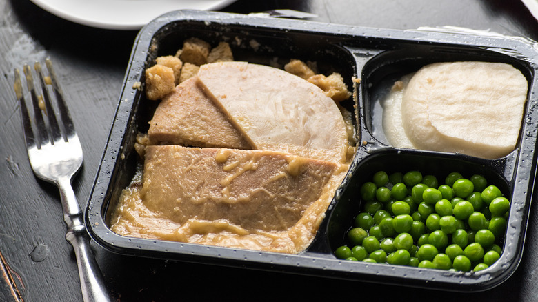 partially eaten tv dinner on table