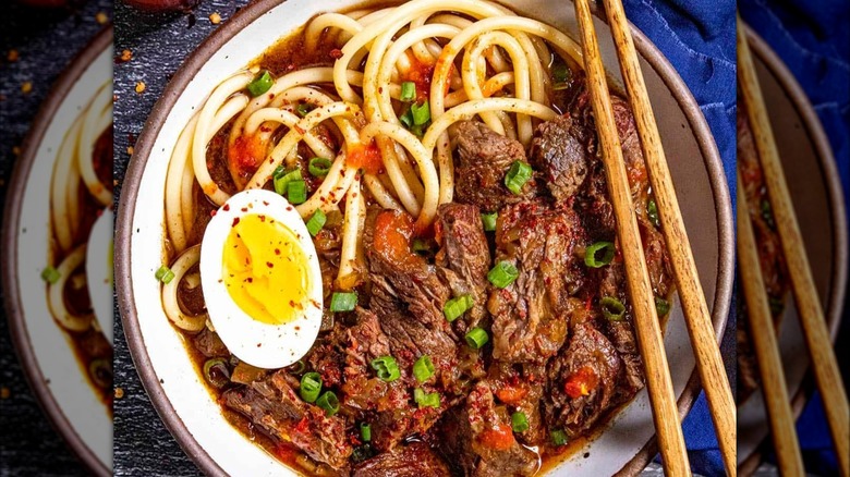 bowl of homemade yakamein soup with chopsticks