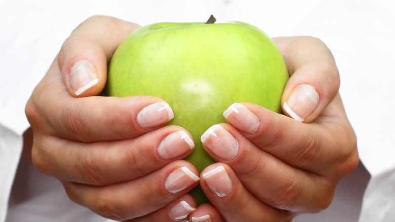 granny smith apple in hands