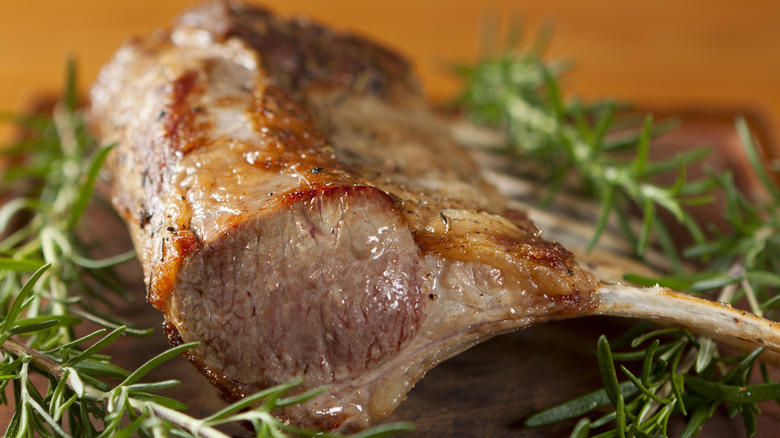 Close up of rack of lamb with fresh rosemary.