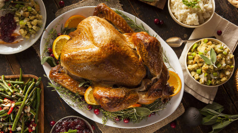 Thanksgiving turkey on table with autumnal side dishes