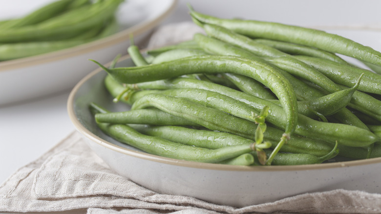 Raw green beans in a bowl