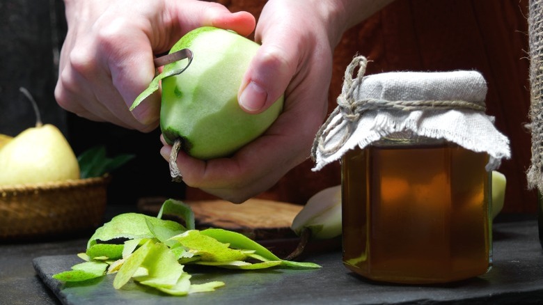 Woman peeling a pear