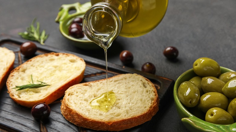 Drizzling olive oil on bread