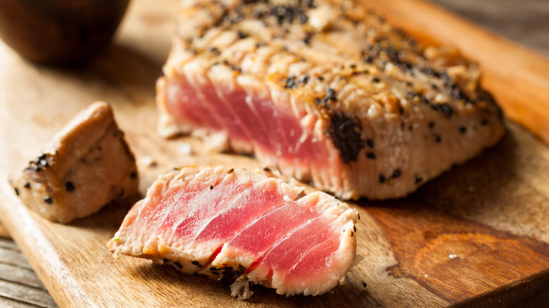 slice tuna steak on a cutting board