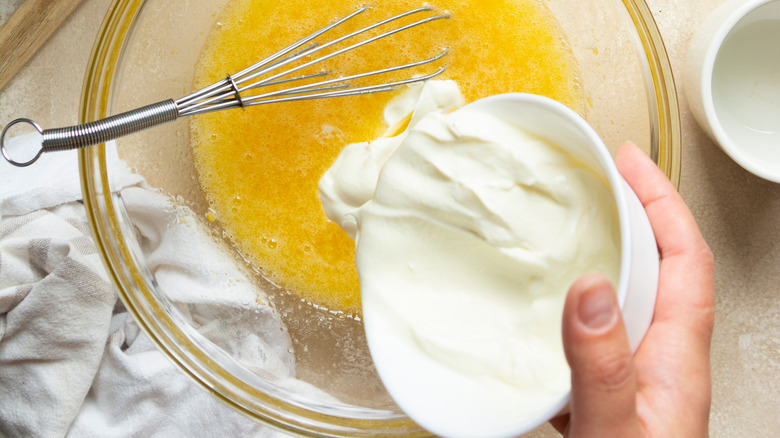 pouring yogurt into eggs