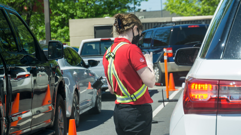 staff member working at Chick-fil-A drive thru