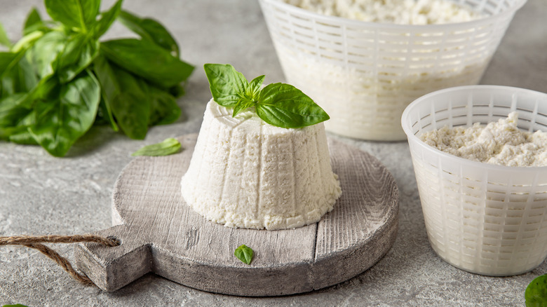 block of ricotta next to baskets of ricotta