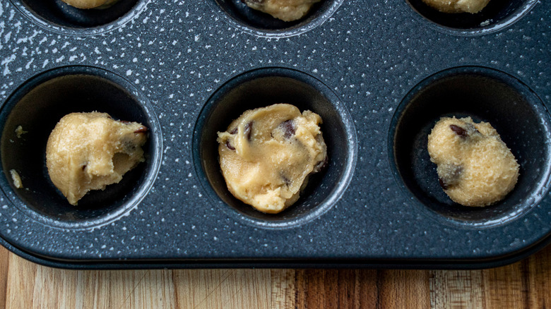 cookie dough balls in muffin pan