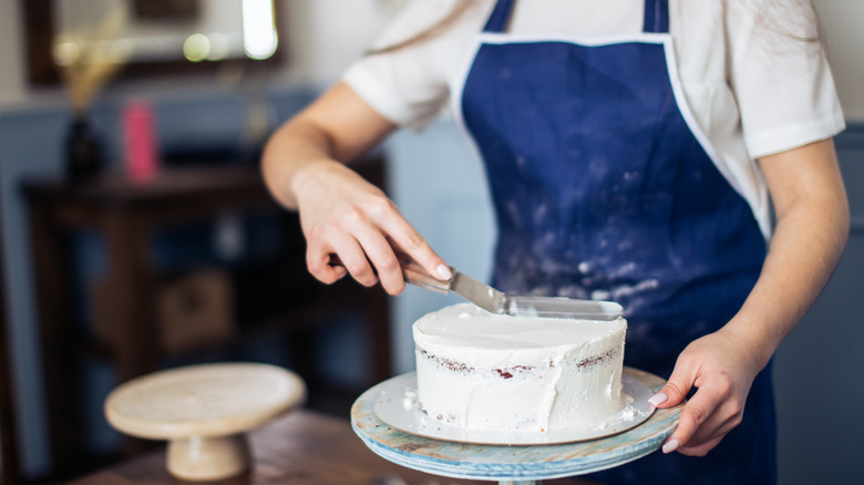 Woman frosting a cake