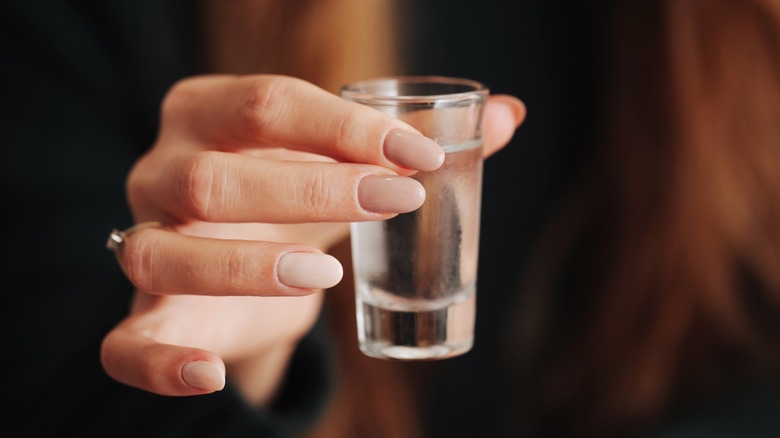 hand holding vodka shot