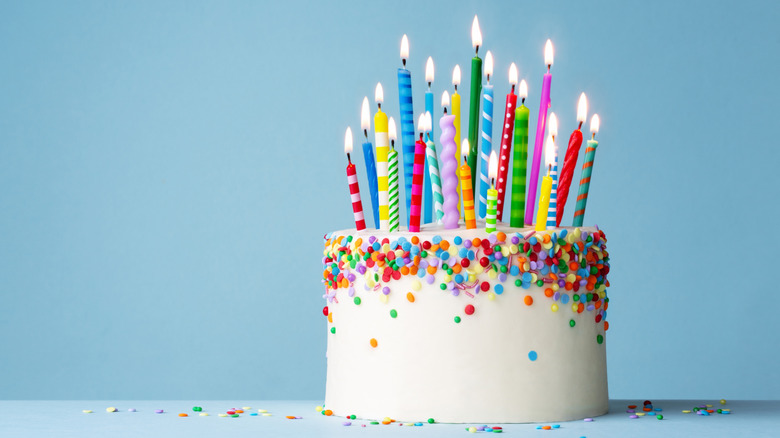 celebration cake with smooth buttercream frosting and colorful candles