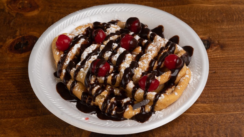 Funnel cake with chocolate drizzle and fruit