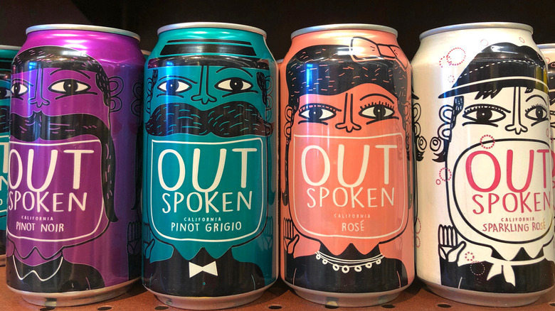 four cans of outspoken wine