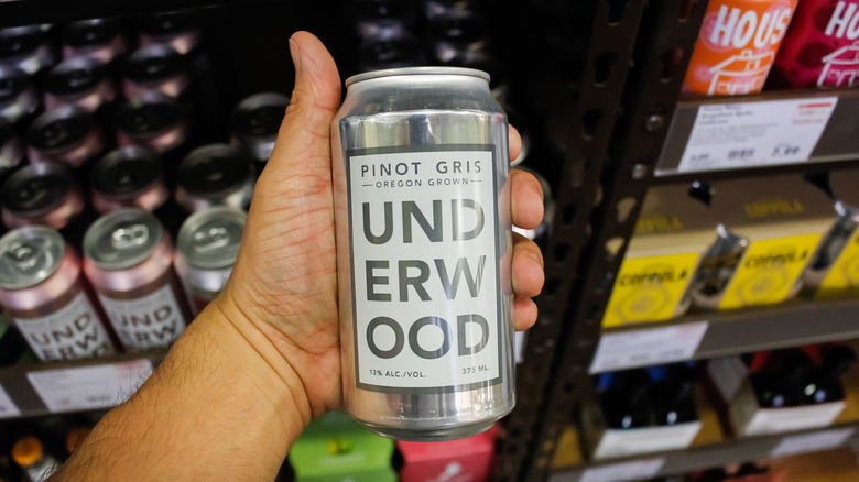 hand holding can of underwood wine