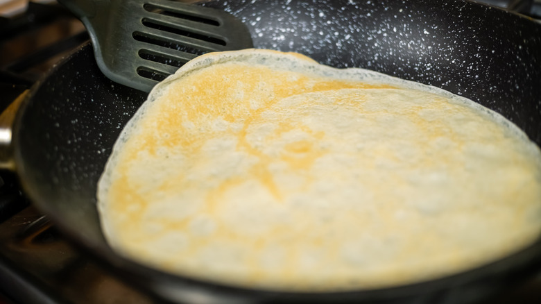 flipping pancake in nonstick pan