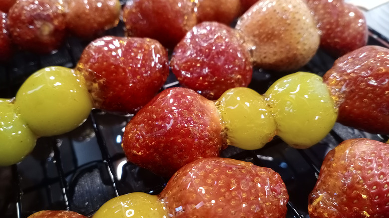 Tanghulu skewers of candied cherry tomatoes and strawberries