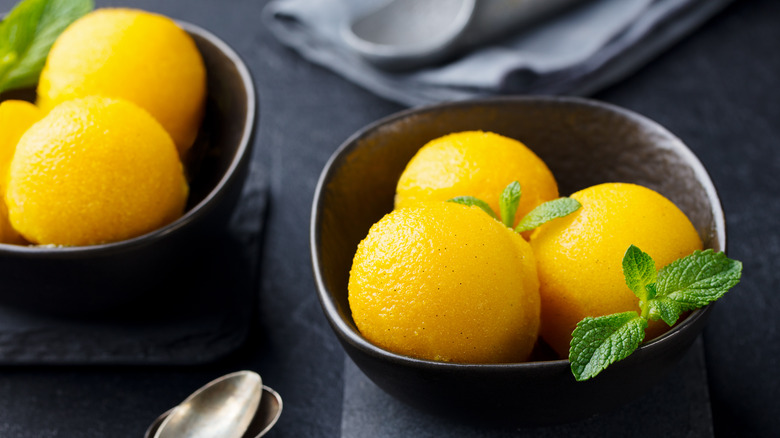 black bowls of mango sorbet