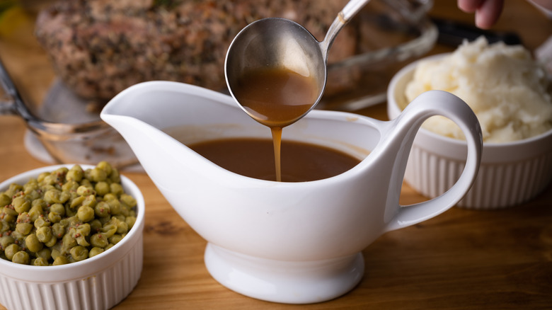 Smooth gravy ladled into gravy boat