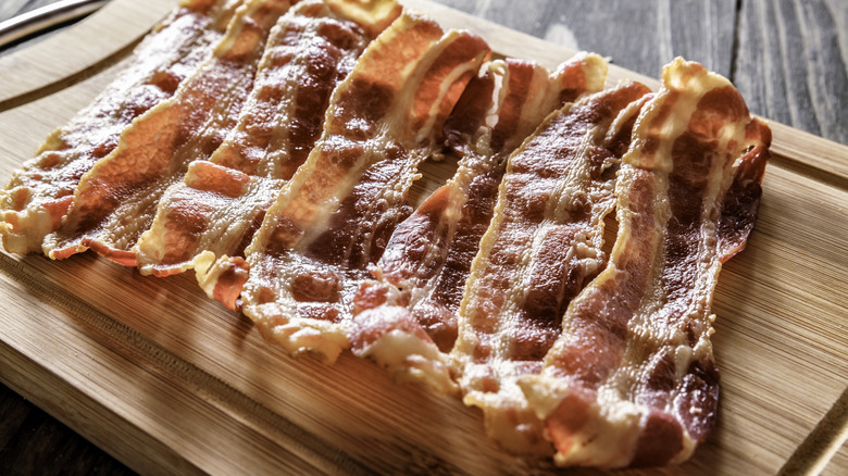 Bacon slices on a wooden board