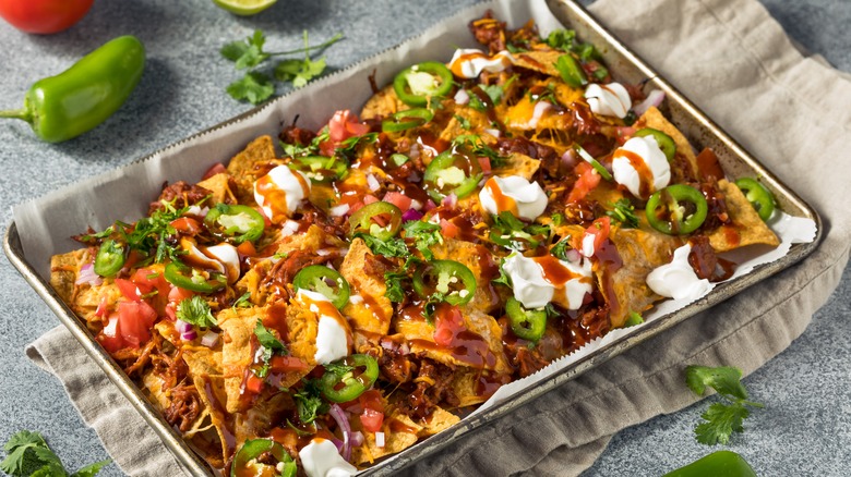 Pulled pork nachos in aluminum baking pan