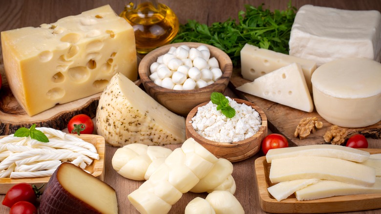 Different types of cheese on a wooden table