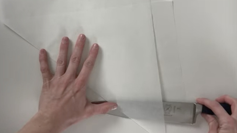 using knife to cut a parchment triangle