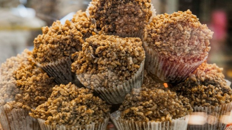 a pile of chocolate crackles for sale at a bakery