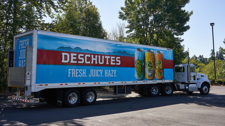 A large delivery truck branded with Deschutes beer, and the tagline "Fresh. Juicy. Hazy."