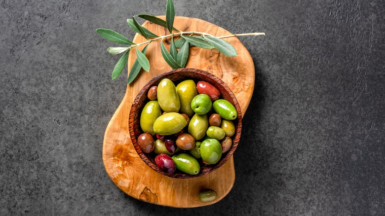 Multicolored olives on a cutting board 