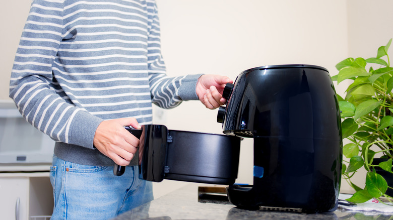 Person using air fryer