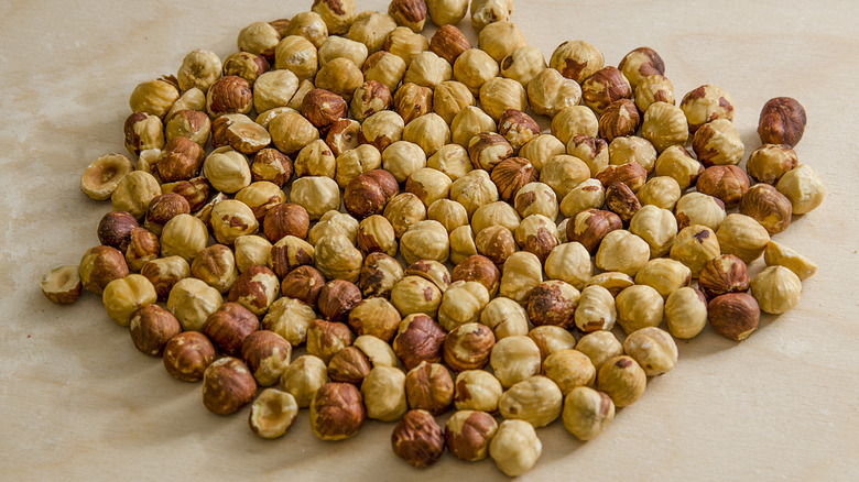 Toasted hazelnuts on wooden surface