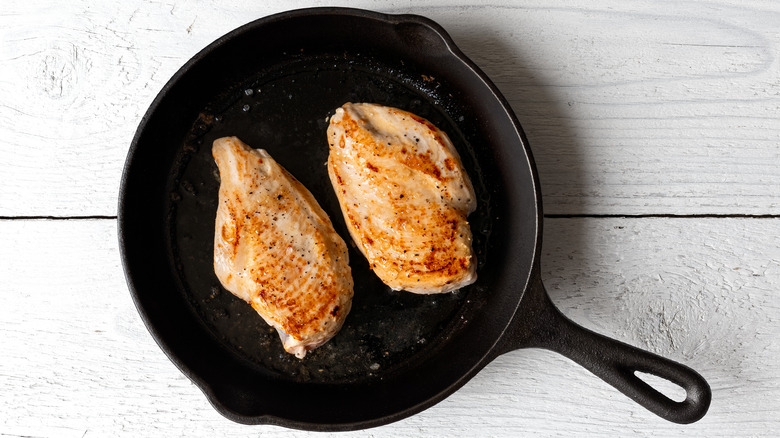 whole chicken breast seared in cast iron skillet